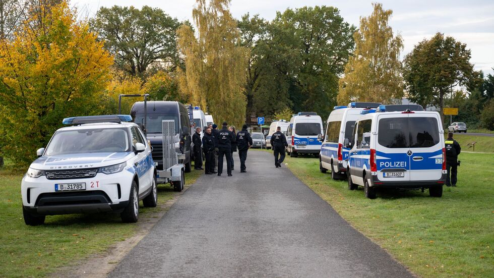 Polizeiautos stehen auf einer Wiese in Tauche.  Polizeiautos stehen auf einer Wiese in Tauche.